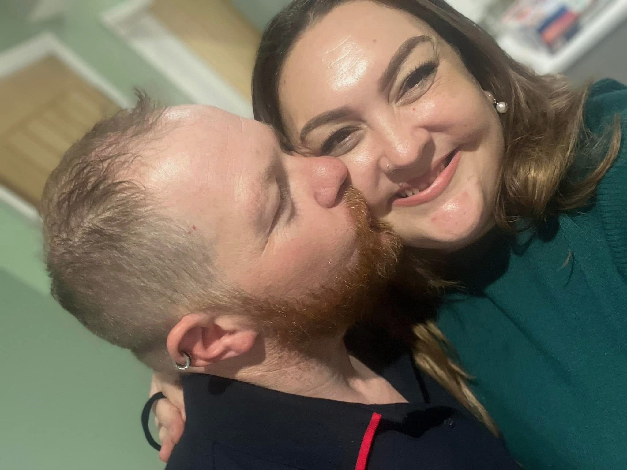 Raychel and Drew sharing a kiss at home